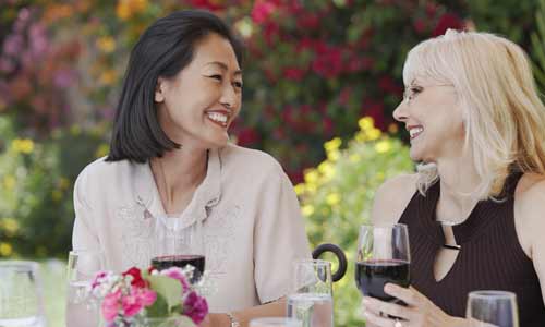 women talking over lunch natural-looking smiles and confidence